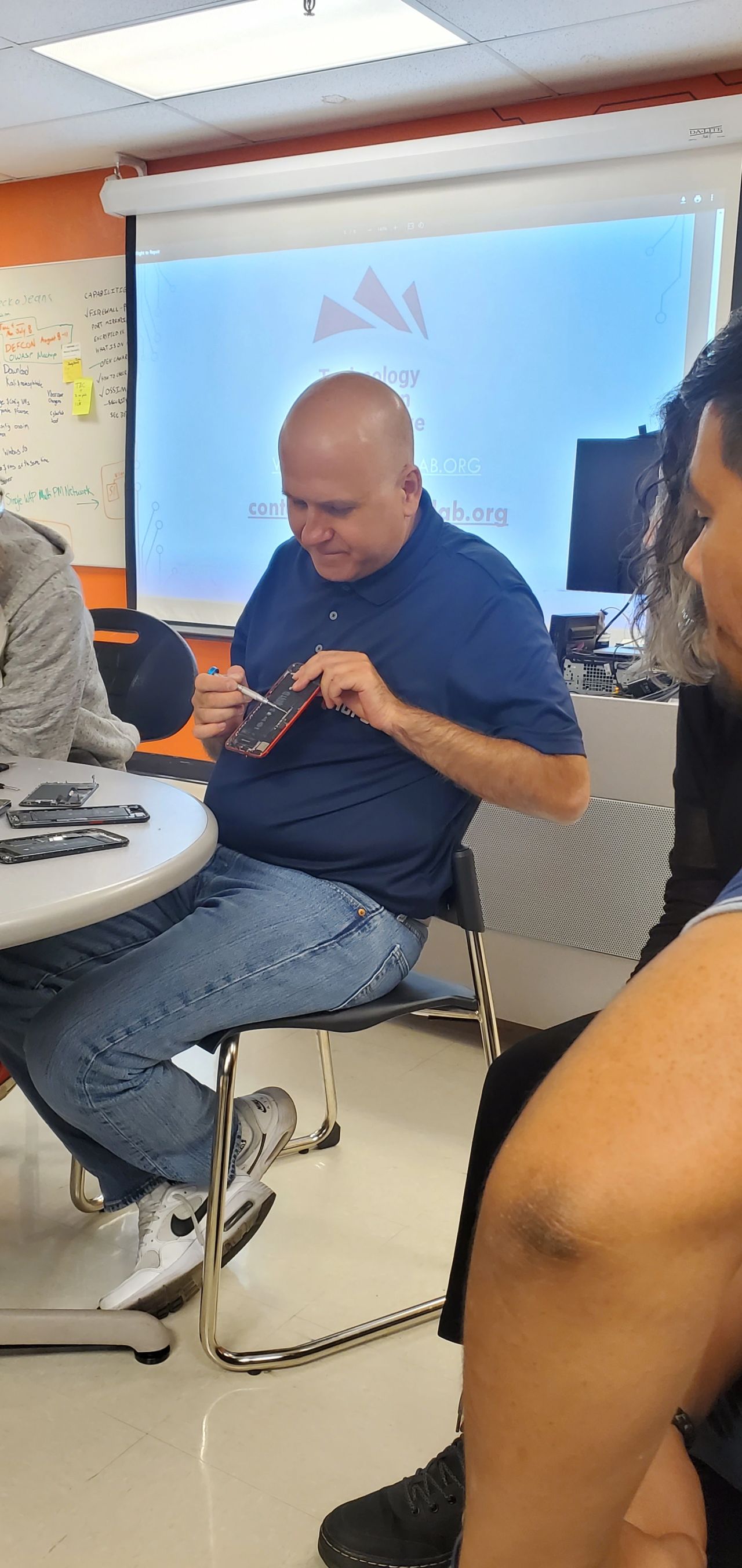 Mustafa pointing out what pieces are what in an iphone